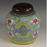 A Chinese ovoid ginger jar, painted in polychrome enamels with flowers and symbols, 17cm high,