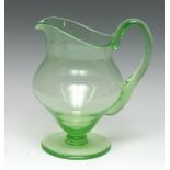 A Victorian uranium glass helmet shaped water jug, scroll handle, circular foot, ground pontil,