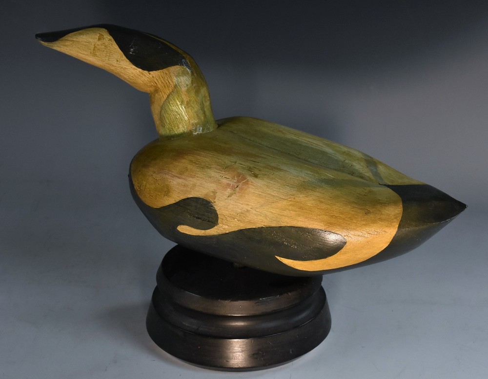 A North Canadian Type Eider Duck Decoy on a stand, carved and painted wood,