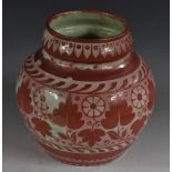 A Persian ovoid lustre vase, decorated with leaves and floral roundels,