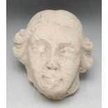 A Medieval limestone sculptural fragment, carved as the head of a man, 20cm high, 19cm wide,