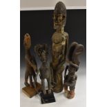 Tribal Art - an Igbo Ikenga figure, the horned warrior alusi stands, a knife in his right hand,