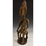 Tribal Art - a large Bamana fertility figure, carved as a mother feeding her infant child,