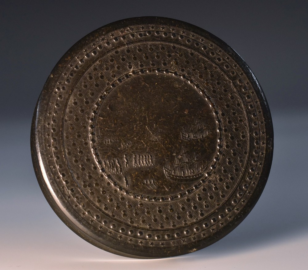 A 19th century bois durci circular snuff box, the cover depicting a naval battle, 8cm diam, c.