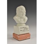 A ceramic desk bust, of Sir Winston Churchill, printed quotation, square base,