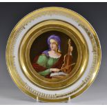 A Paris porcelain circular cabinet plate, painted with St Cecilia, within broad gilded borders,