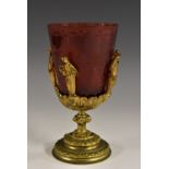 A Bohemian ruby glass and gilt metal goblet, the bucket shaped bowl cut with architectural views,