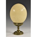The Wunderkammer - an ostrich egg, mounted on a Regency bronze pedestal, 24cm high, the base c.