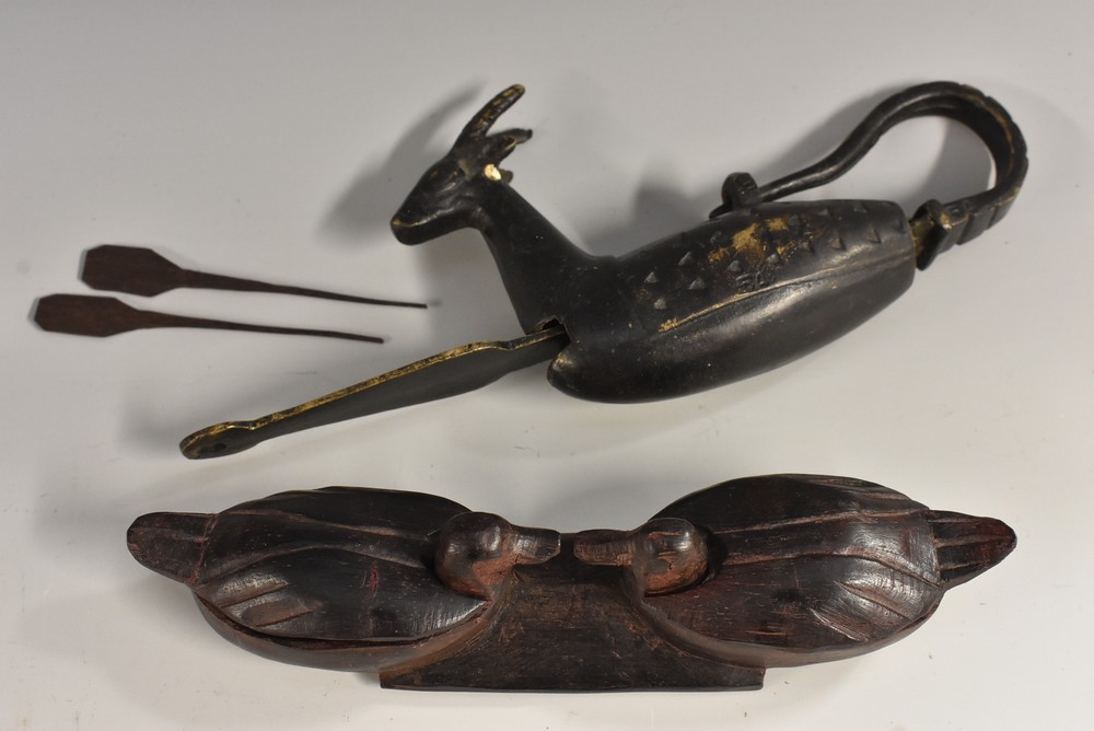 A Nepalese brown patinated bronze zoomorphic door lock, cast as a stylized deer,