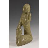 A large North American/Canadian Inuit soapstone carving, of a kneelin woman, 29cm high,