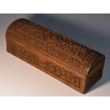 An Indian sandalwood domed rectangular casket, well carved with roundels, lotus,