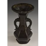 A Chinese dark patinated hexagonal baluster vase, in the Archaic taste, shaped rim,