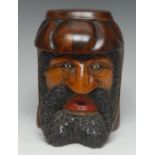 A Black Forest novelty tobacco jar, carved and painted as the head of a bearded man, glass eyes,