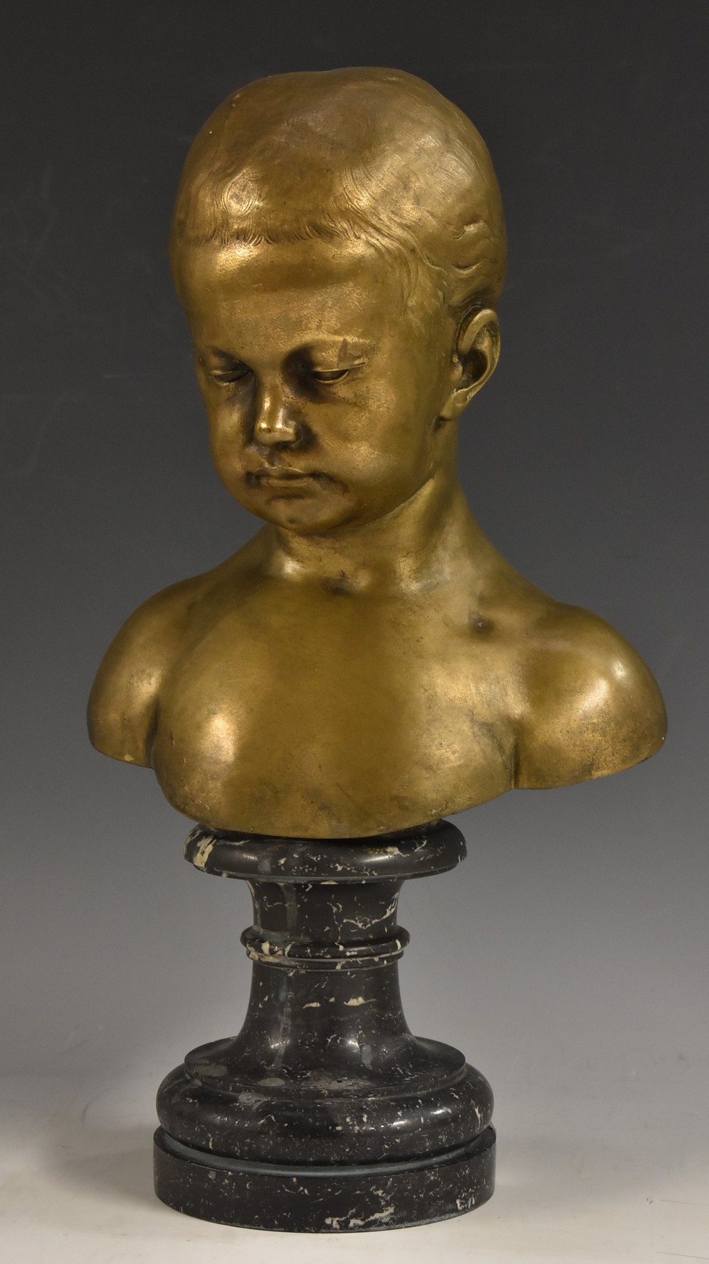 After Jean-Antoine Houdon, a bronze bust, of a child, turned marble socle,