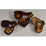 A harlequin set of three graduated meerschaum pipes,