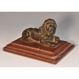 Grand Tour School (19th century), a dark patinated bronze, of a lion, his paw upon a globe,