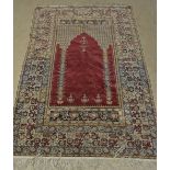 A Middle Eastern woollen Islamic prayer rug,