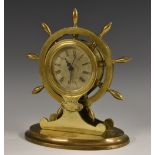 An early 20th century brass novelty clock case, as a ship's wheel, 7cm silvered dial,