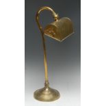 An early 20th century brass library desk lamp, the swan neck column with two adjustments,