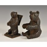 A Black Forest novelty table vesta, carved as a bear with a hod on his back, 9cm high,