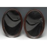 A pair of early 20th century mahogany oval easel table mirrors, quite plain, 38cm x 27.
