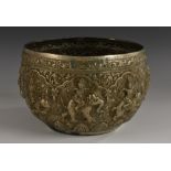 A 19th century Burmese bowl, chased in high relief with deities riding mythical and stylised beasts,
