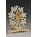 A 19th century alabaster pocket watch stand, pierced and carved with scrolling leafy branches,