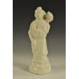 A Chinese Blanc de Chine Dehua porcelain figure, well-modelled as a winking sage,