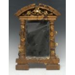 An early 20th century gilt gesso and softwood architectural looking-glass, arched cresting,