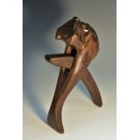 A Black Forest lever-action novelty nut cracker, carved as the head of a terrier dog, glass eyes,
