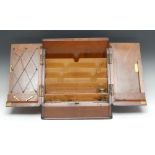 A Victorian walnut slope front stationery box, hinged twin-covers enclosing stepped divisions,