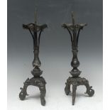 A pair of Chinese bronze pricket candlesticks, each cast in the Ming taste as a lotus,
