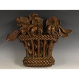 An 18th century oak architectural carving, of a basket of flowers, 37cm high,