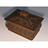 A 19th century Tyrolean box and cover, carved in relief with stiff leaves and acanthus,