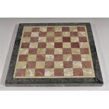 A pietra dura chess board, inlaid with a field of alternating specimen marbles, 30.