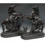 French School (19th century), a pair of large brown patinated spelter equestrian library sculptures,