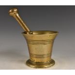An 18th century bronze pestle and mortar, flared rim above two reeded bands, skirted base, 11.