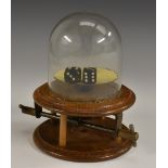 An unusual early 20th century oak mechanical dice shaker,