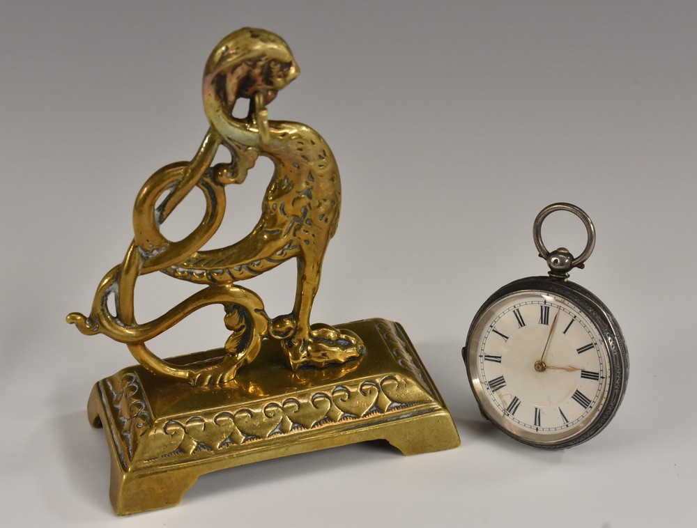 A 19th century brass pocket watch stand, cast as a griffin, spreading base with bracket feet,