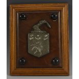 Heraldry - a lead armorial boss, rectangular oak mount, 22.5cm x 18.