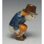 An early 19th century Staffordshire earthenware novelty figural pepperpot, of Roger Giles,