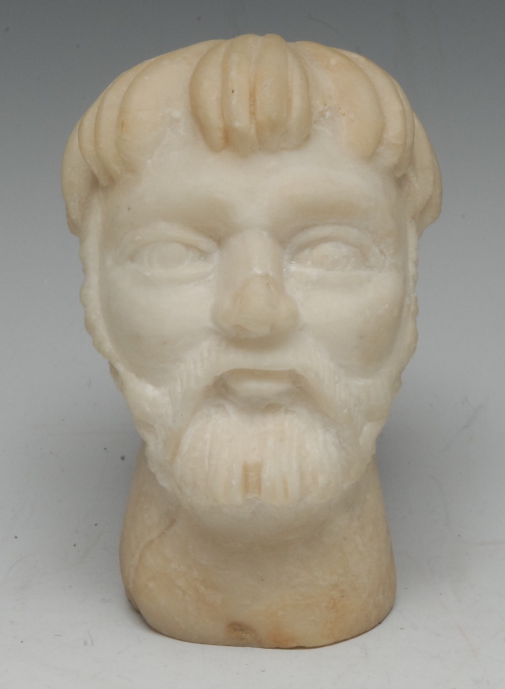 A marble sculptural fragment, carved as the head of bearded gentleman, 14cm high,