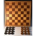 A 19th century boxwood and ebony treen draughts set, each piece engine turned with a sample design,