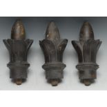 A set of three 19th century oak and parcel gilt architectural finials, each carved as a lotus bud,