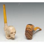 A 19th century meerschaum pipe, carved as the head of a bearded gentleman wearing a cap,