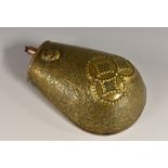A Japanese brass and copper powder flask, chased with stylised motifs on a textured ground,