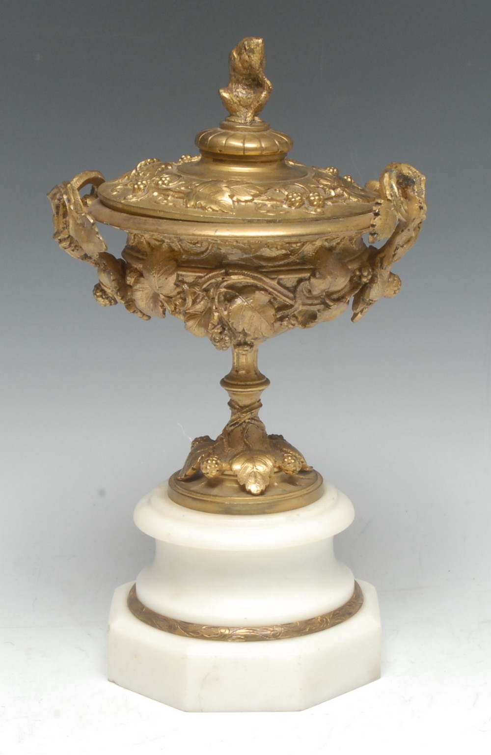 A 19th century gilt bronze mantel urn and cover, cast in relief with fruiting vine,