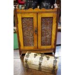A Victorian mahogany smokers cabinet, carved panel doors holding two polished brass drawers c.