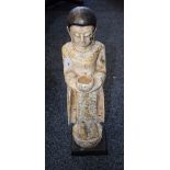 A wooden figure, standing Buddha,
