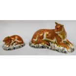 A Royal Crown Derby paperweight, Lioness, gold stopper, boxed; another, Lion Cub, gold stopper,